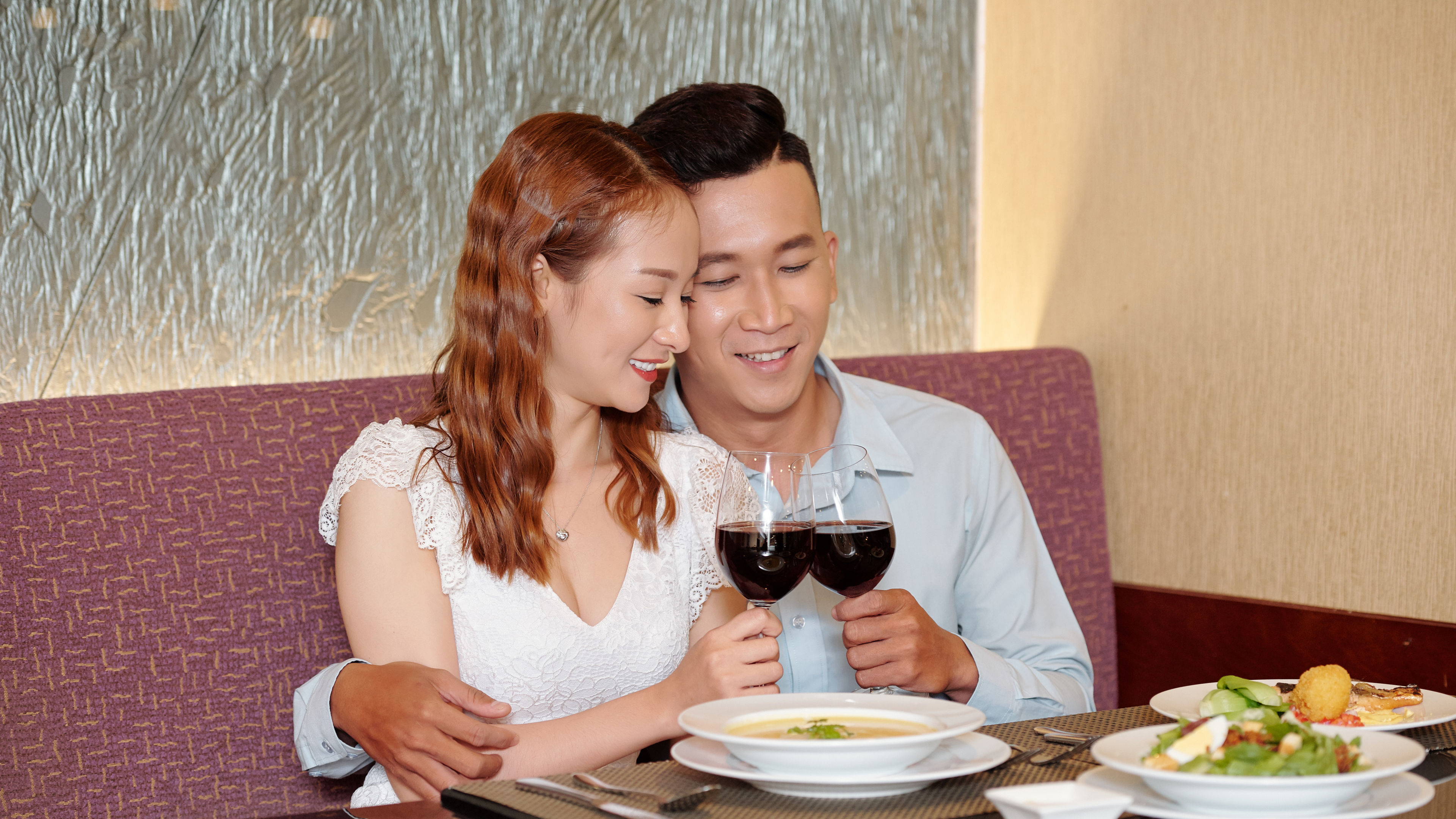 A happy couple enjoys a cozy fine-dining experience 