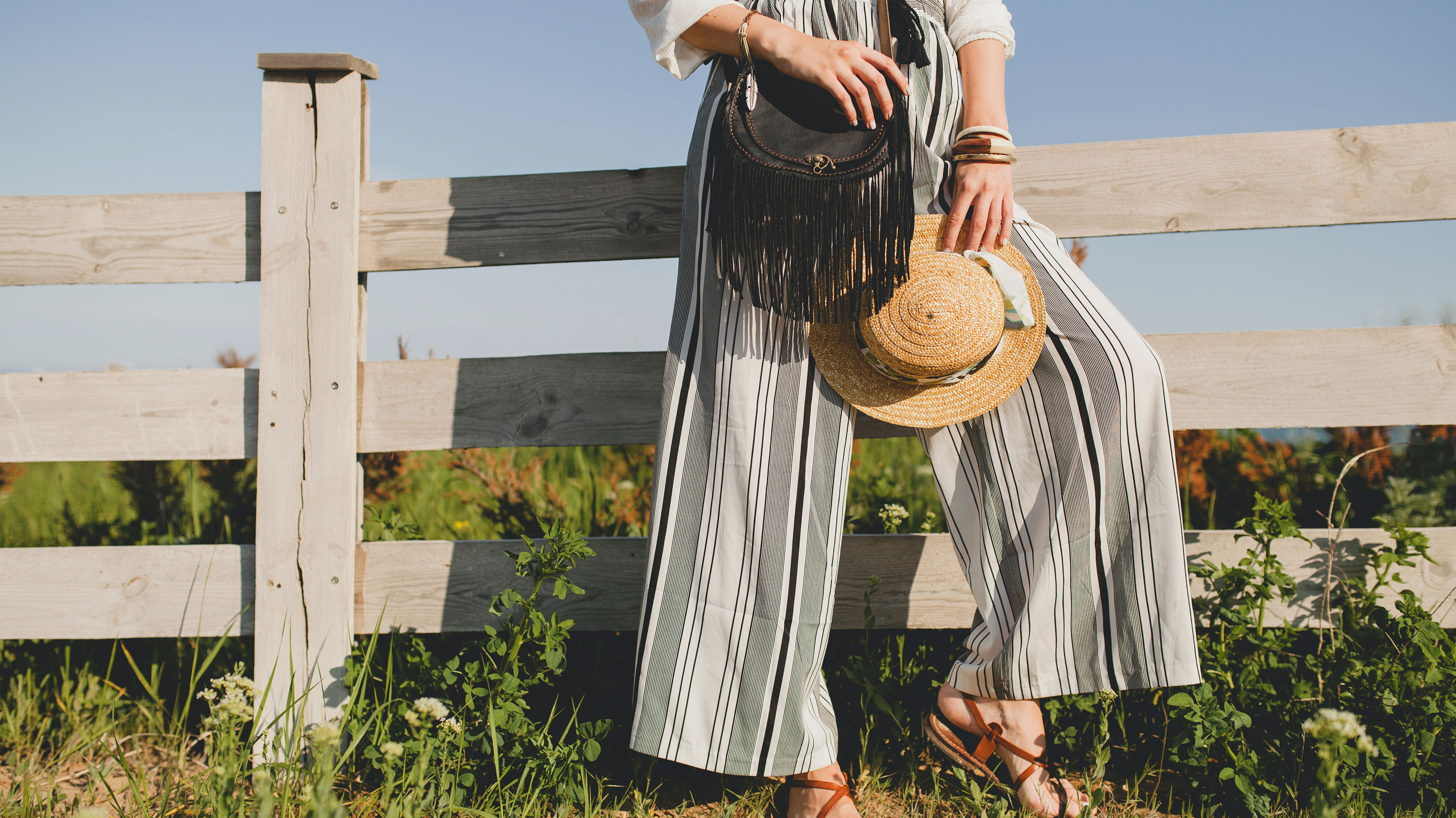 A woman in striped wide-leg pants