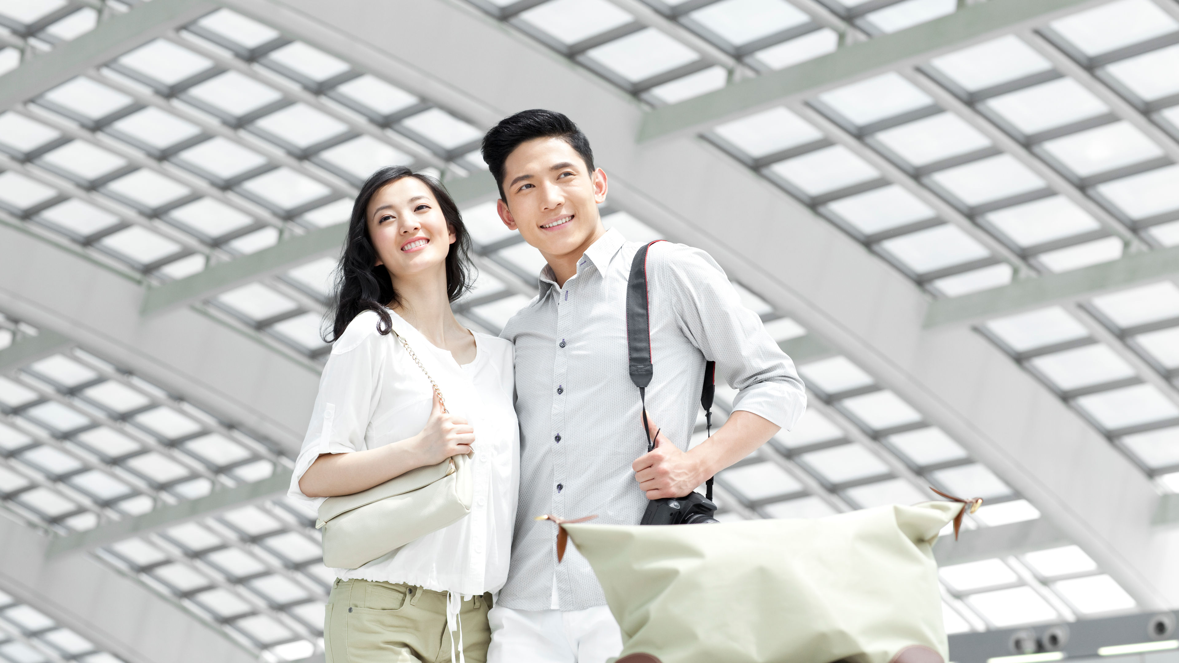 A young couple at a station ready for a trip 