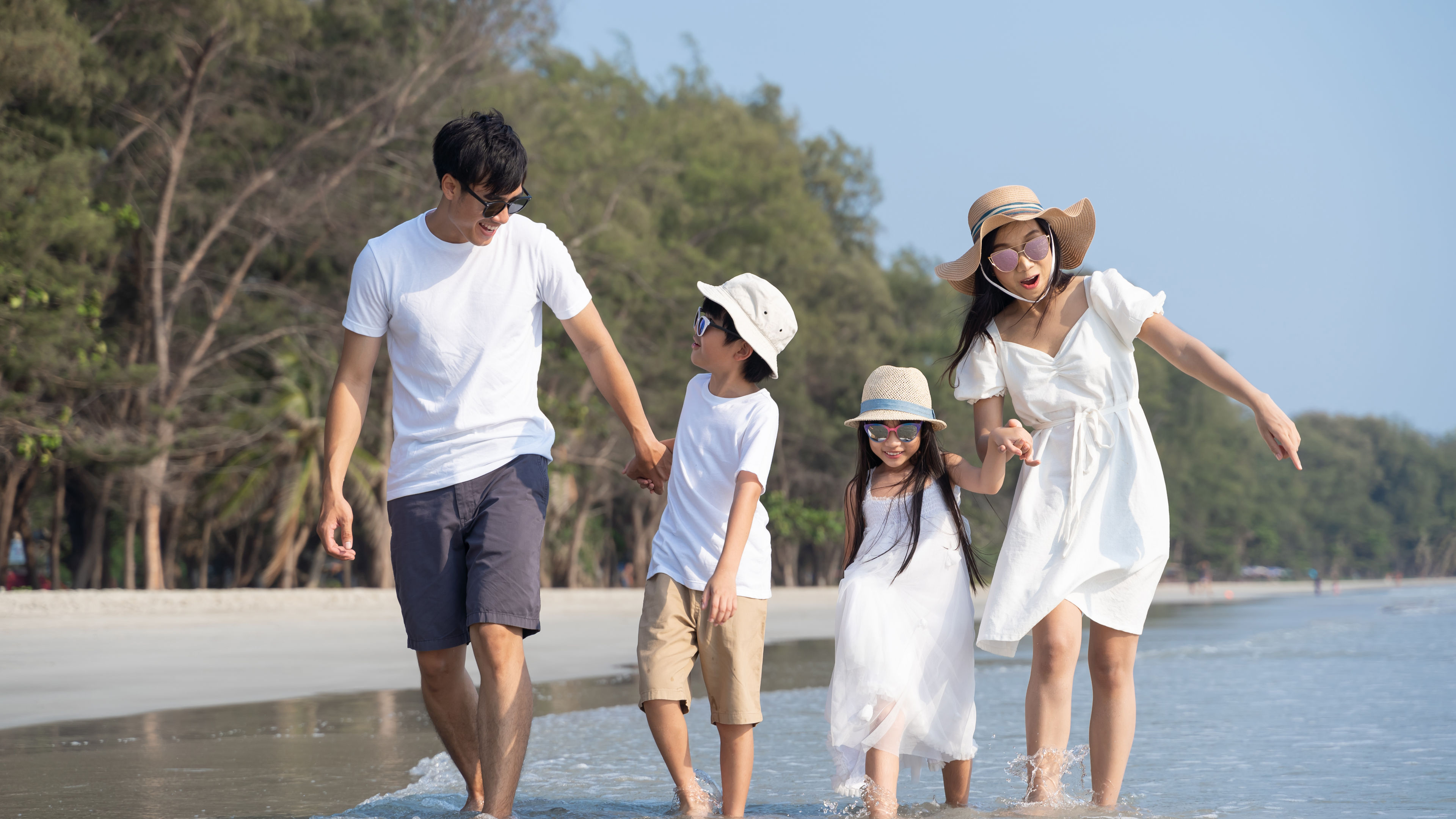 An asian family of four in a beach 