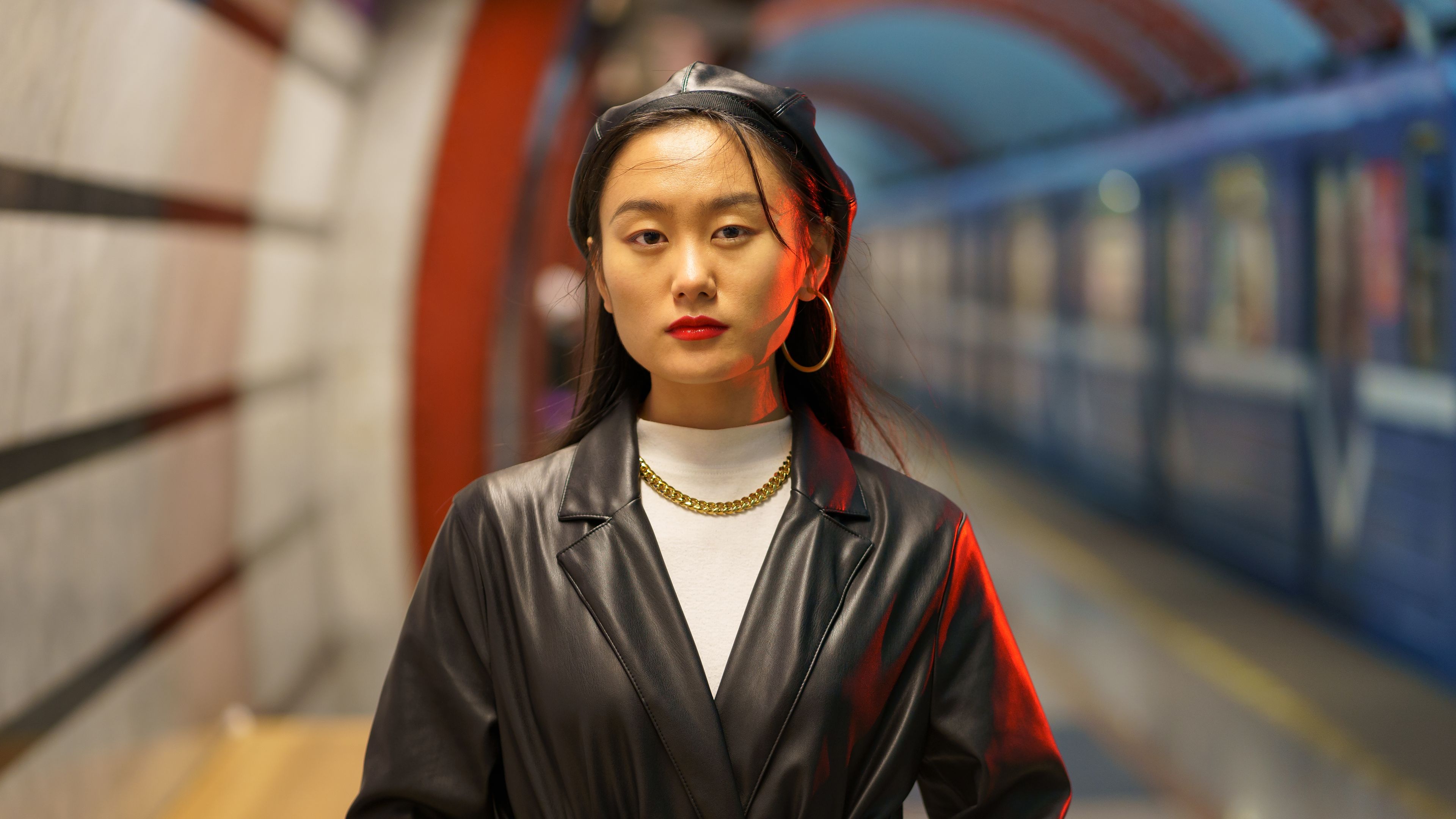 Stylish Asian girl in a leather beret and trench coat. 