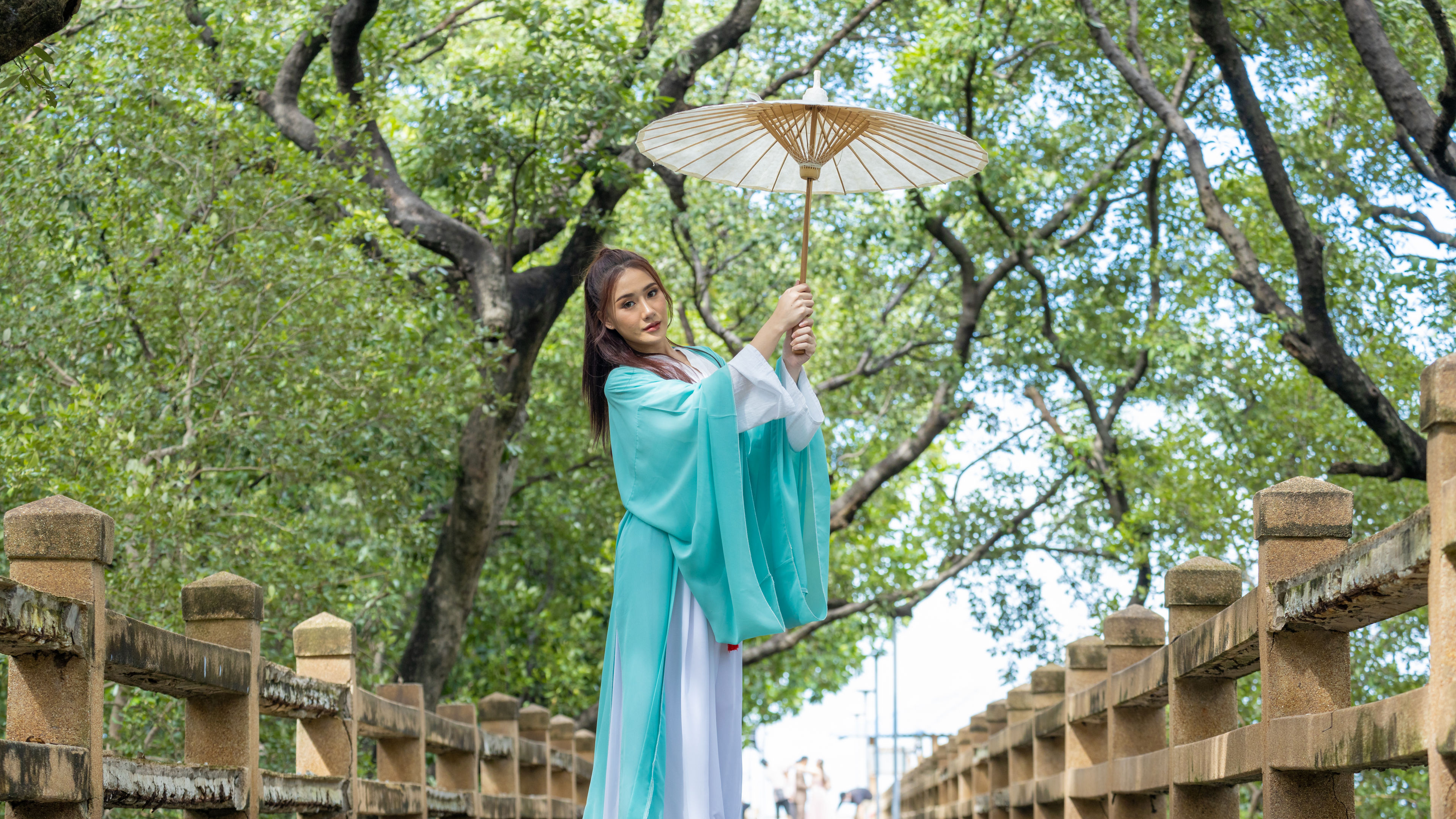 A young and beautiful Asian woman dressed in traditional ancient Chinese attire. 