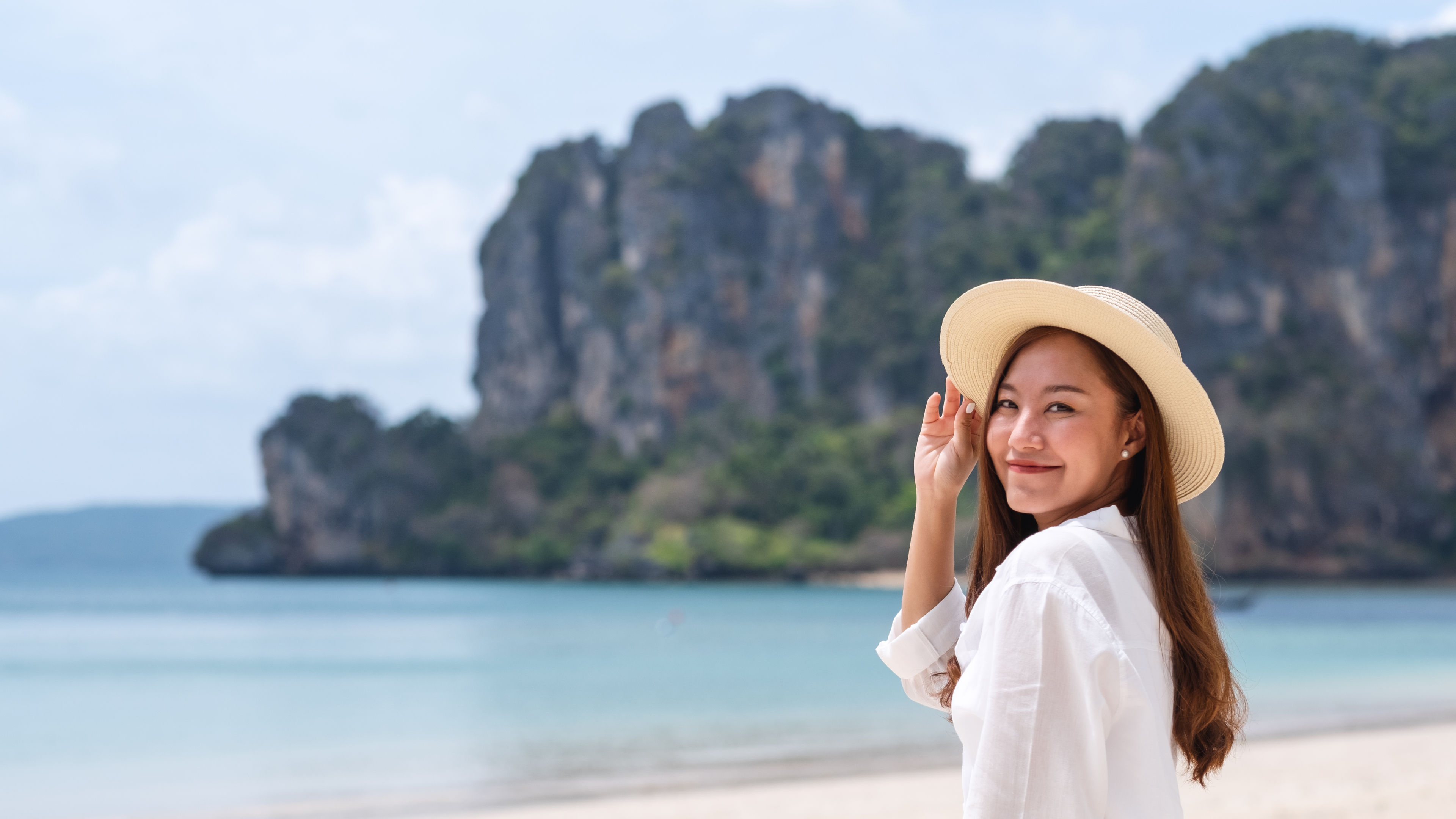 Image of an asian woman strolling in the beach 
