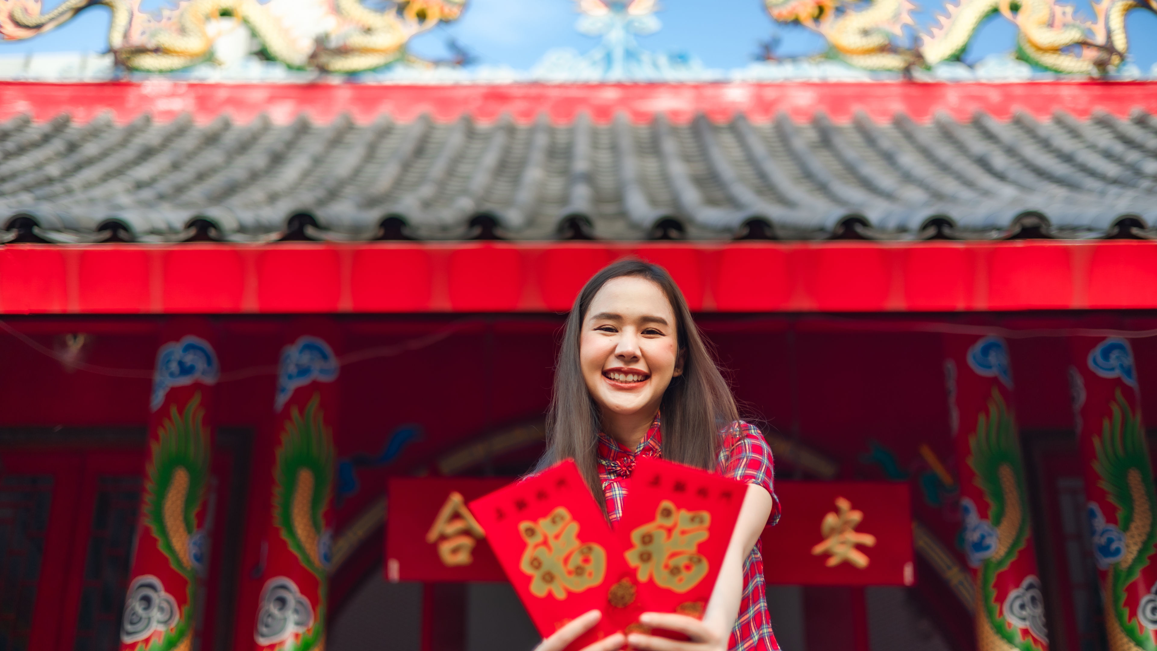 Woman celebrating Chinese New Year in traditional attire. 