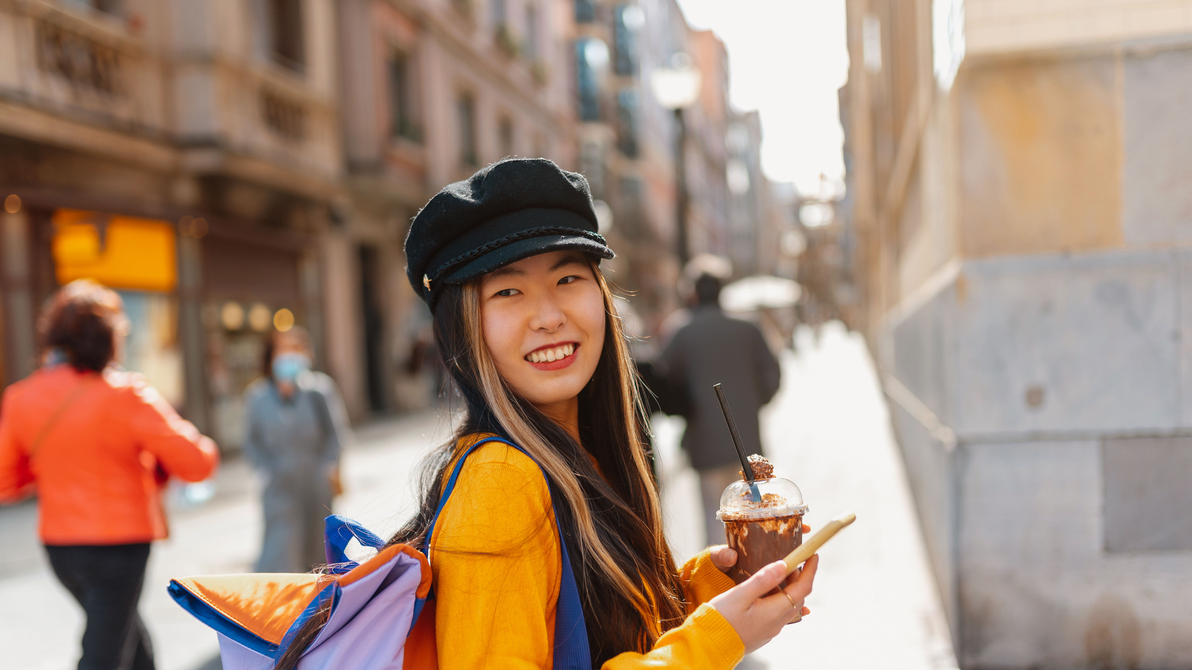 A Chinese tourist enjoying the sights and attractions while exploring Europe. 