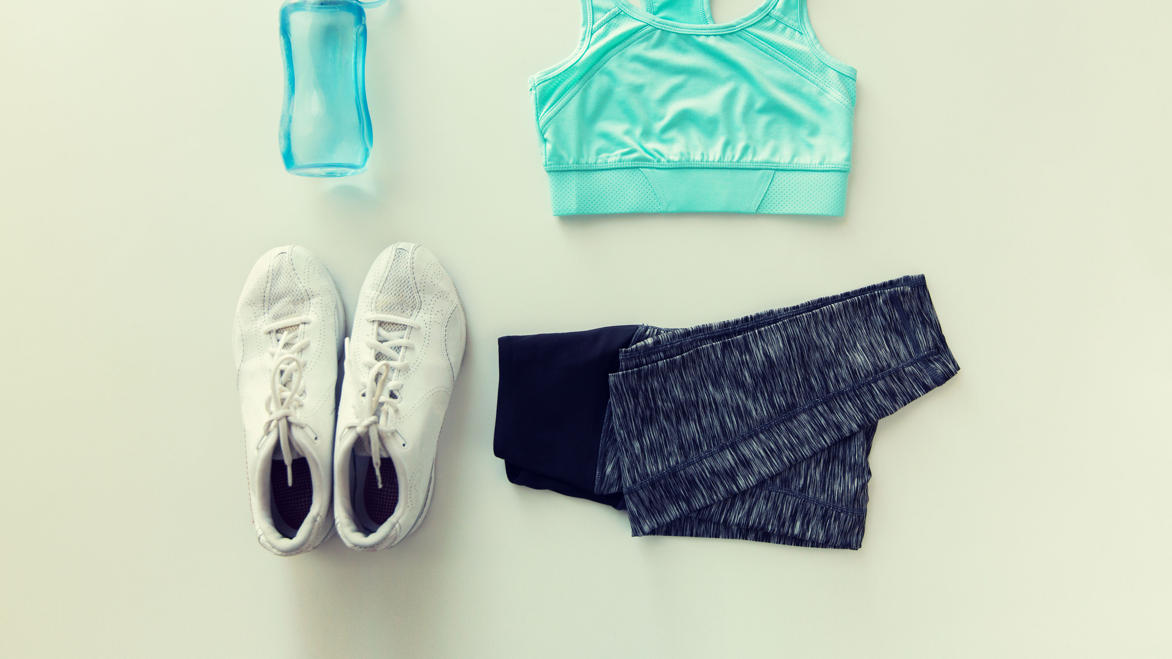 close up of female sports clothing and bottle set