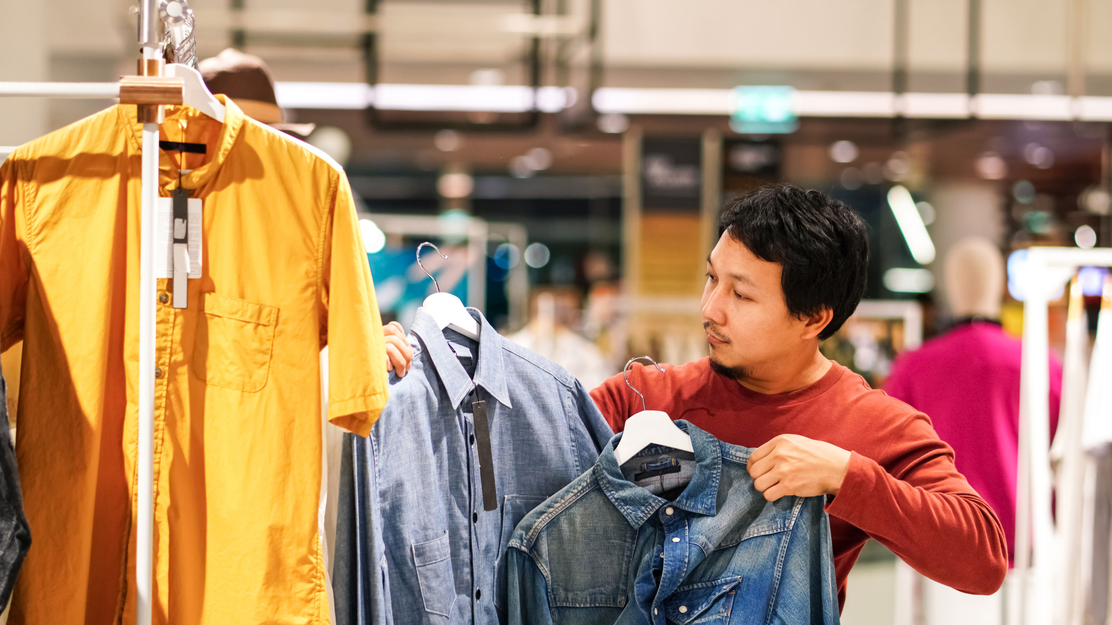 Man choosing for clothes to shop 