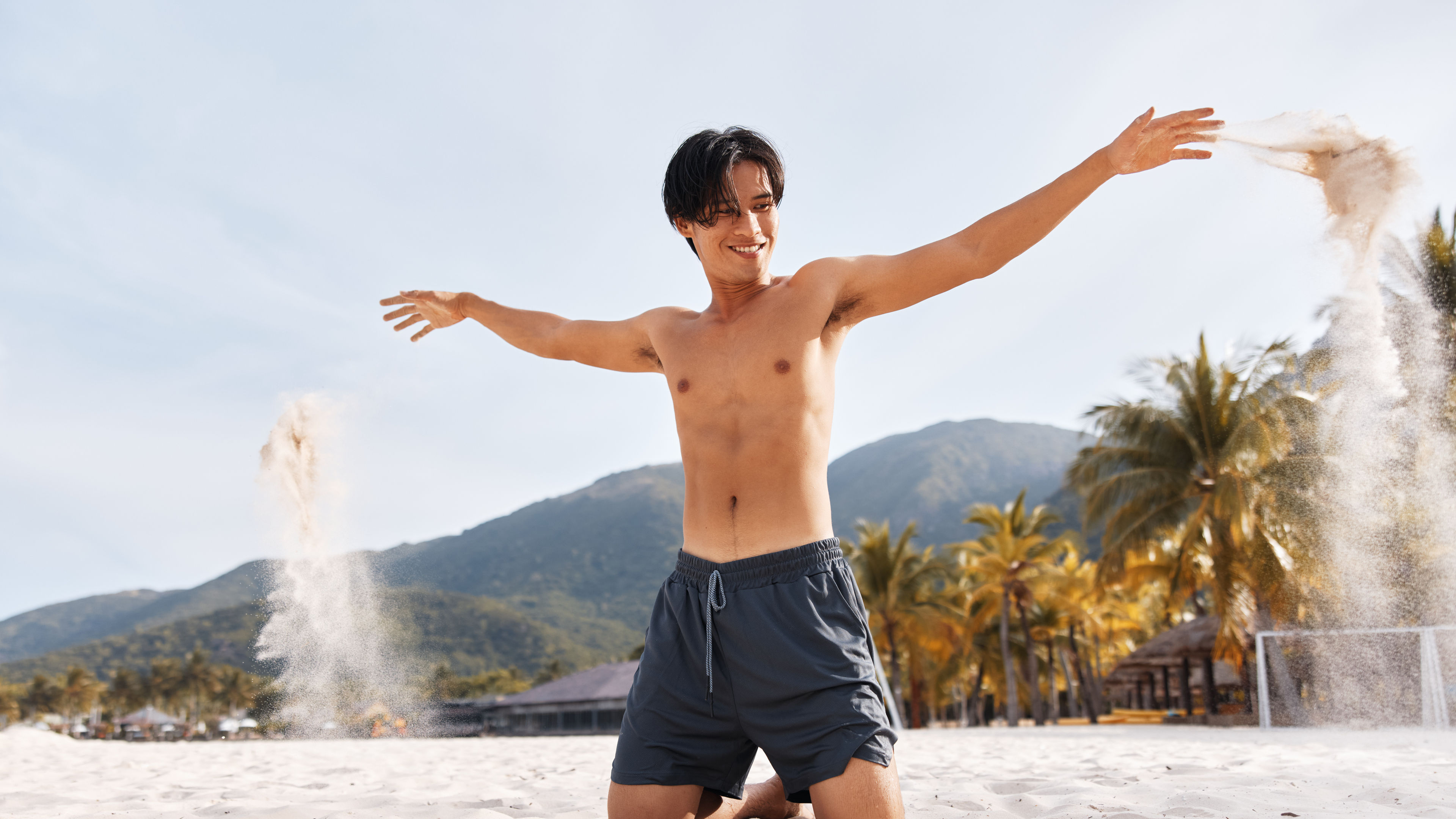 Muscular asian man in a beach 
