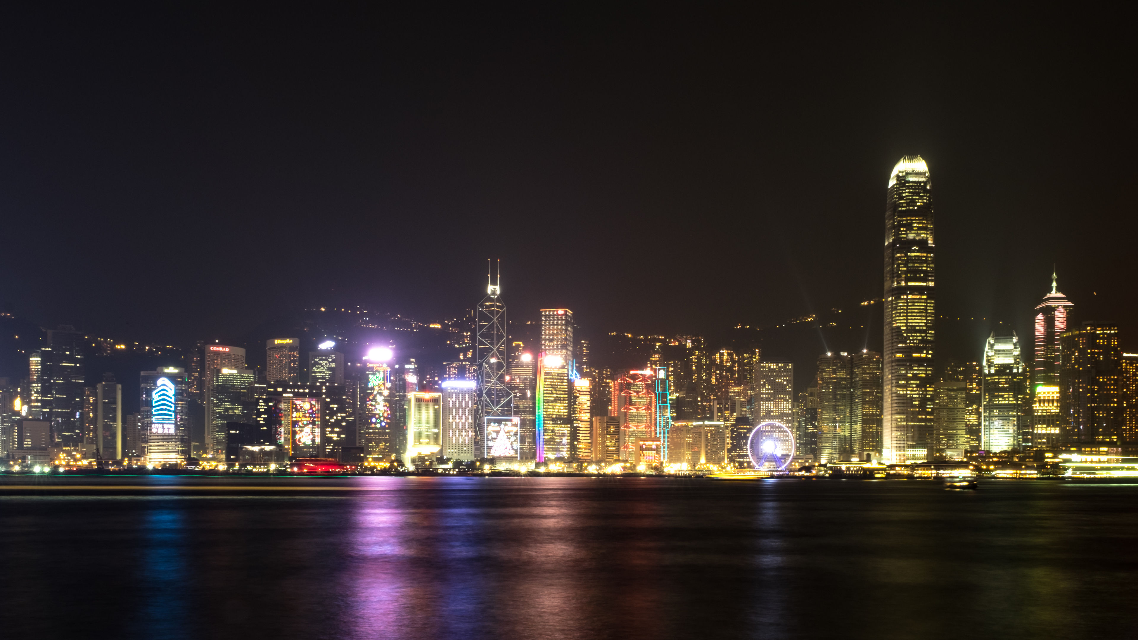 The dazzling Kowloon skyline showcases Hong Kong’s vibrant nightlife, with shimmering lights reflecting on the harbour, capturing the city’s energy.