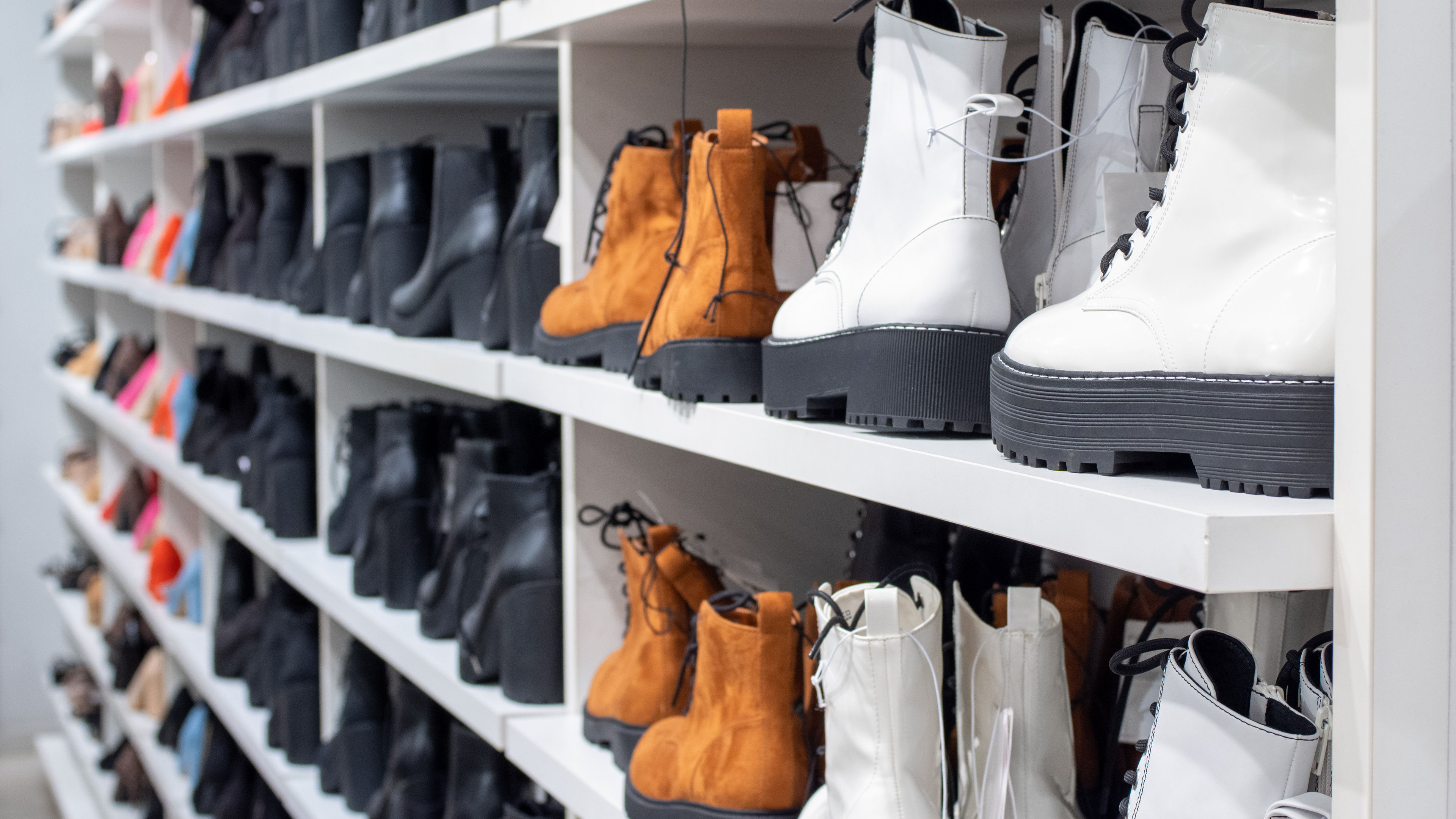 A neatly organized display showcases a variety of fashionable boots