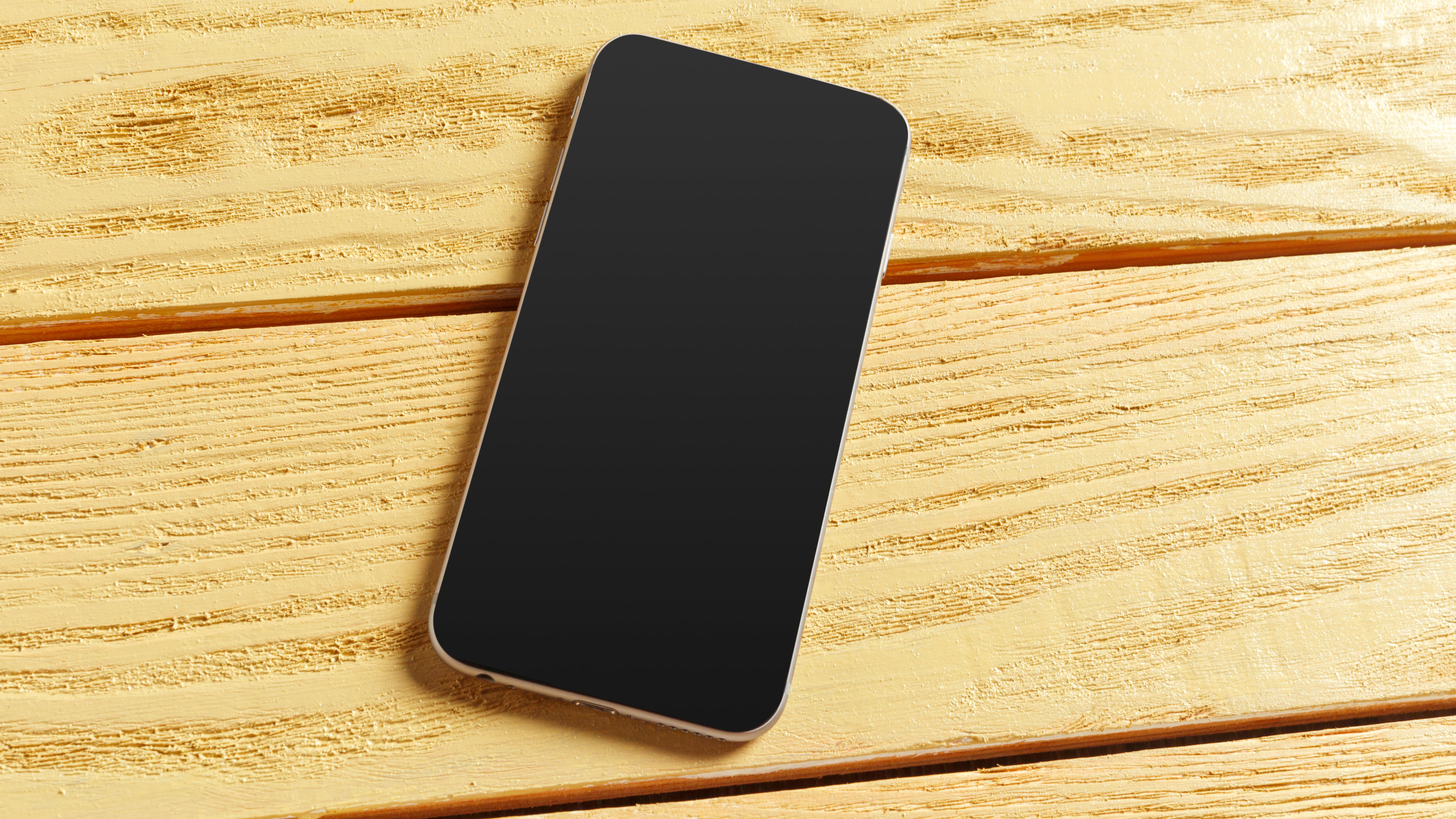 An isolated smartphone with blank screen on table 