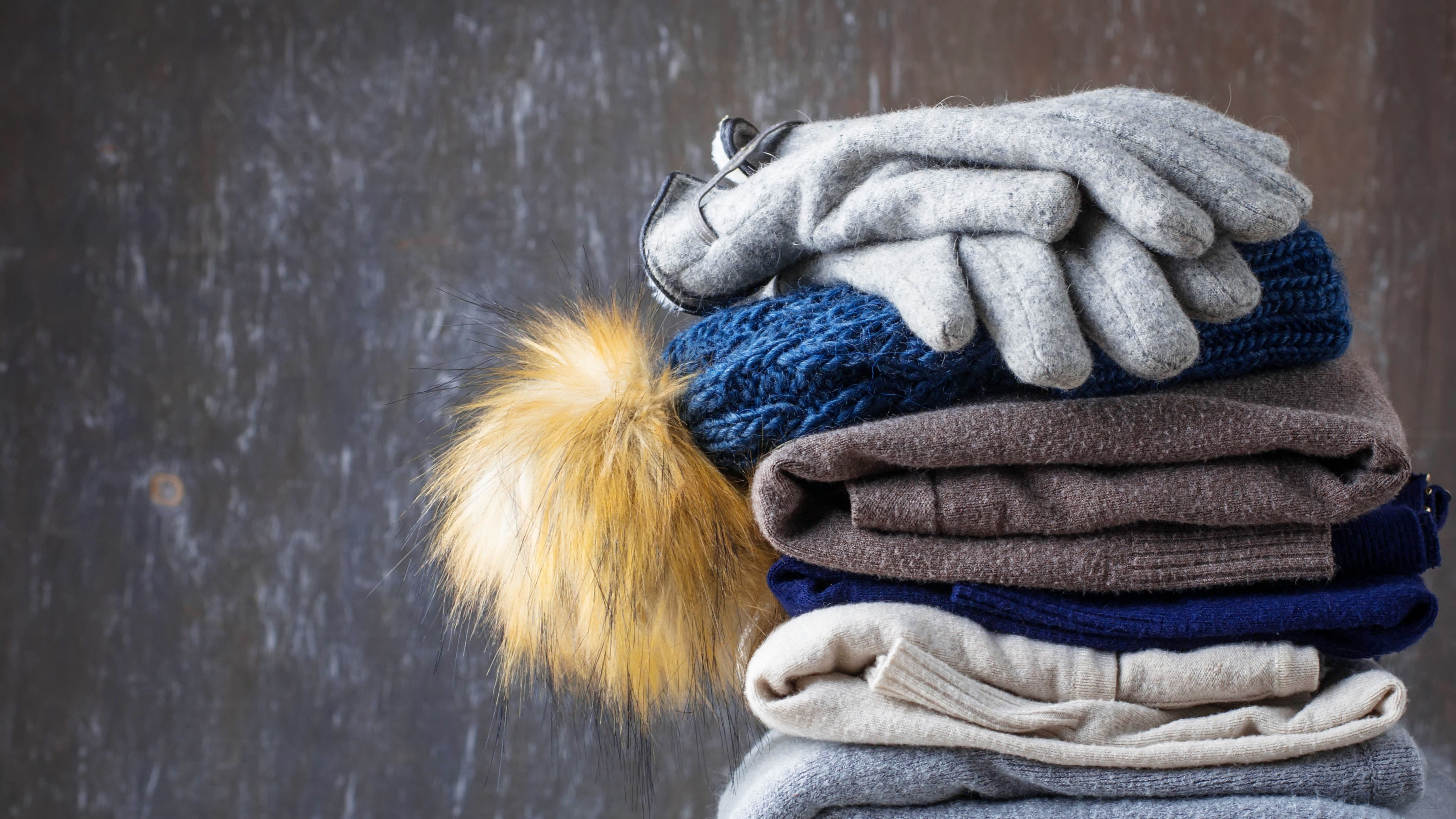 A cozy stack of knitwear and winter accessories. 