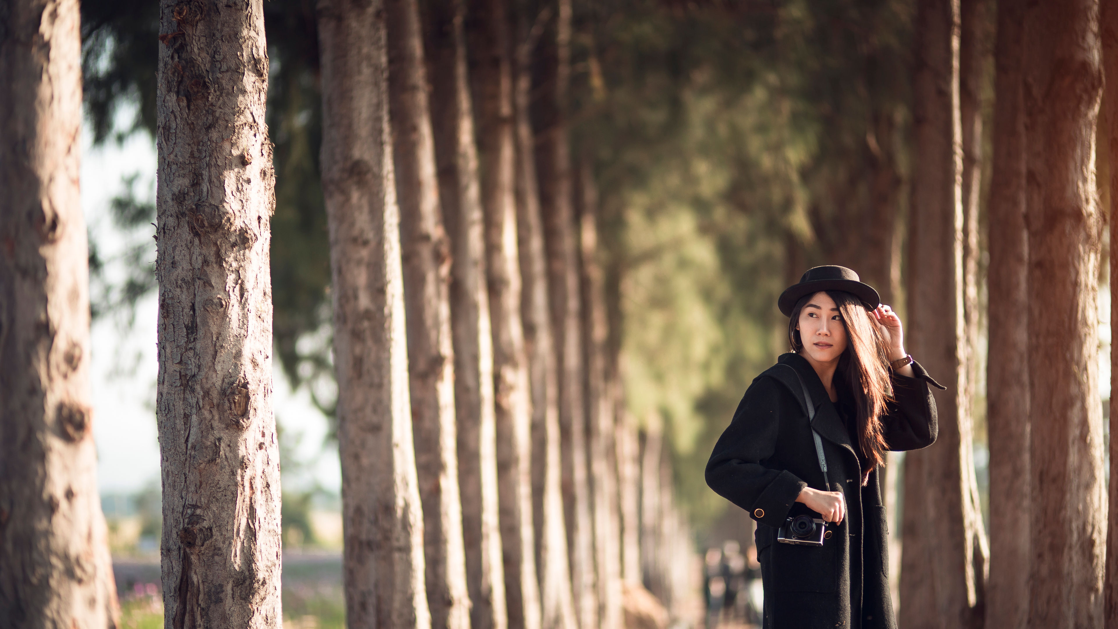 A stylish hipster joyfully capturing a memorable moment with her camera 