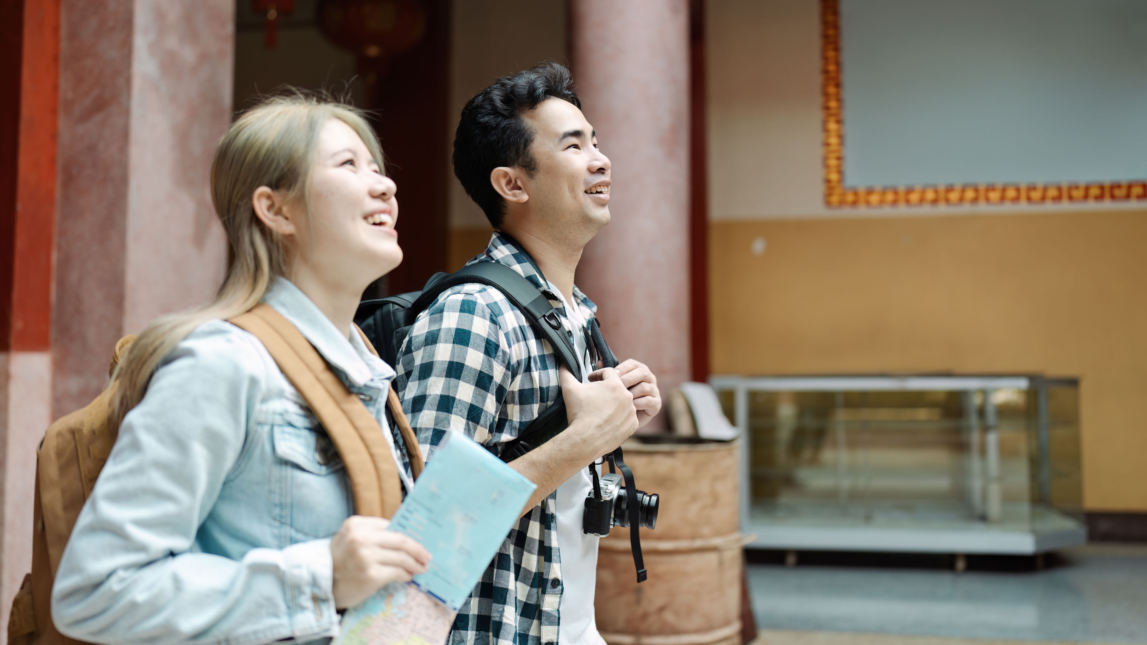 Joyful travellers exploring a cultural landmark and capturing memories together. 