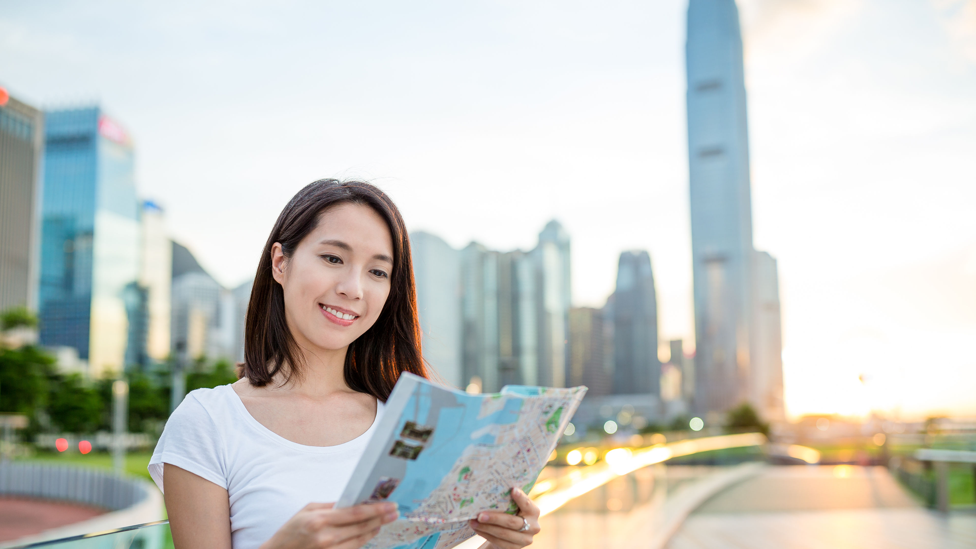 Woman looking on city map in Hong Kong 