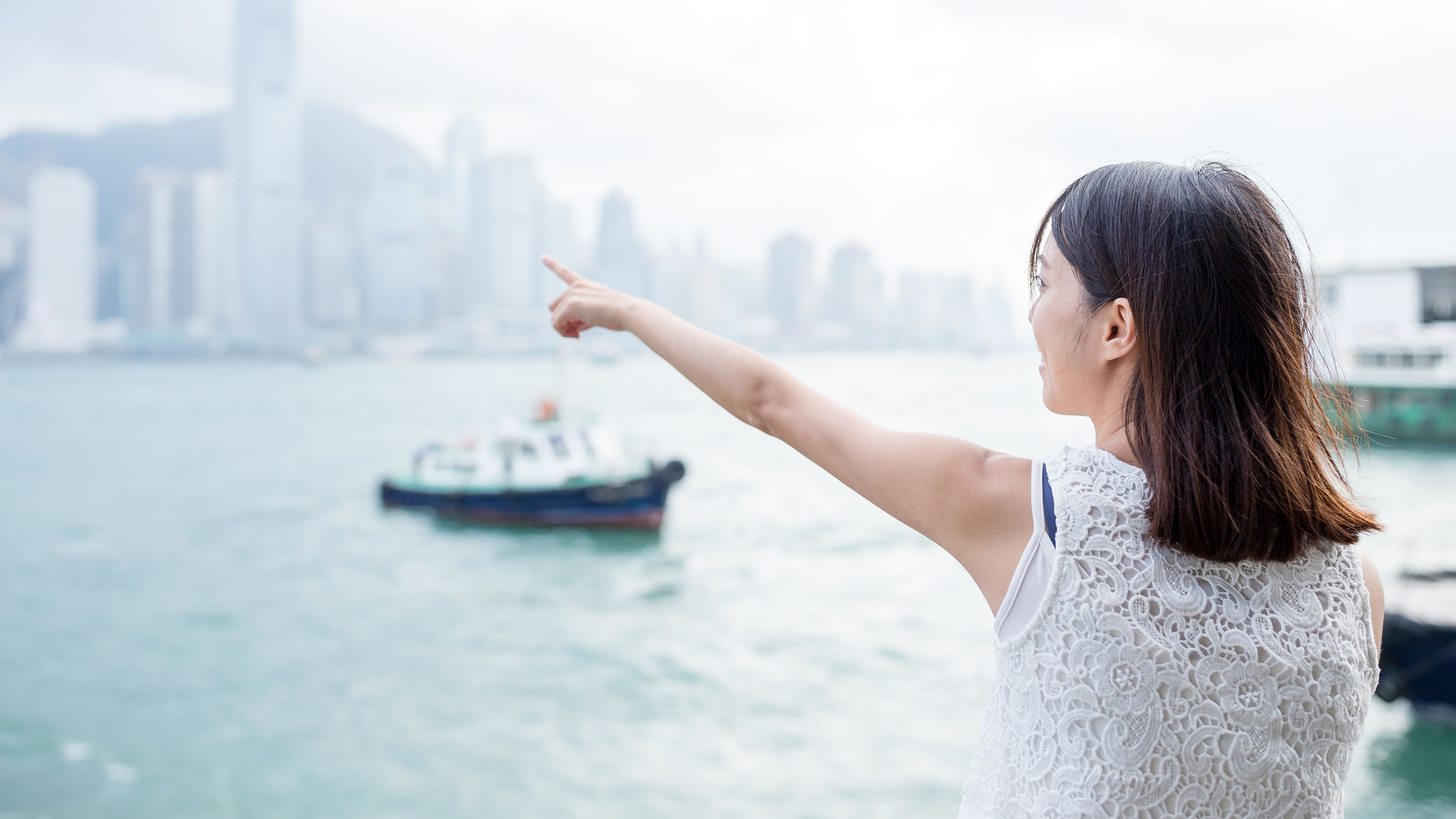 Woman’s finger point to the location in Hong Kong island 