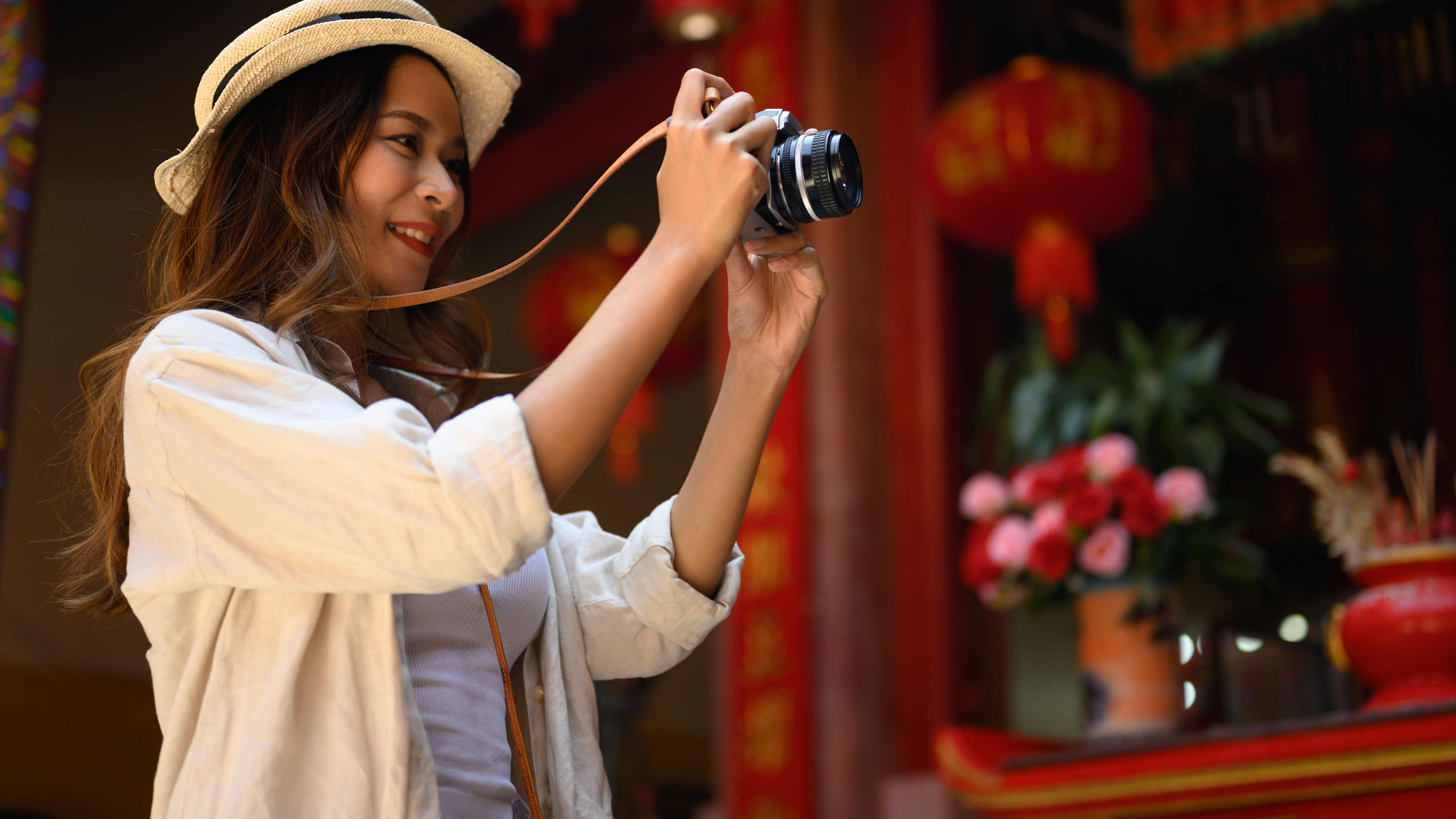 Tourist woman taking a photo with her camera. 