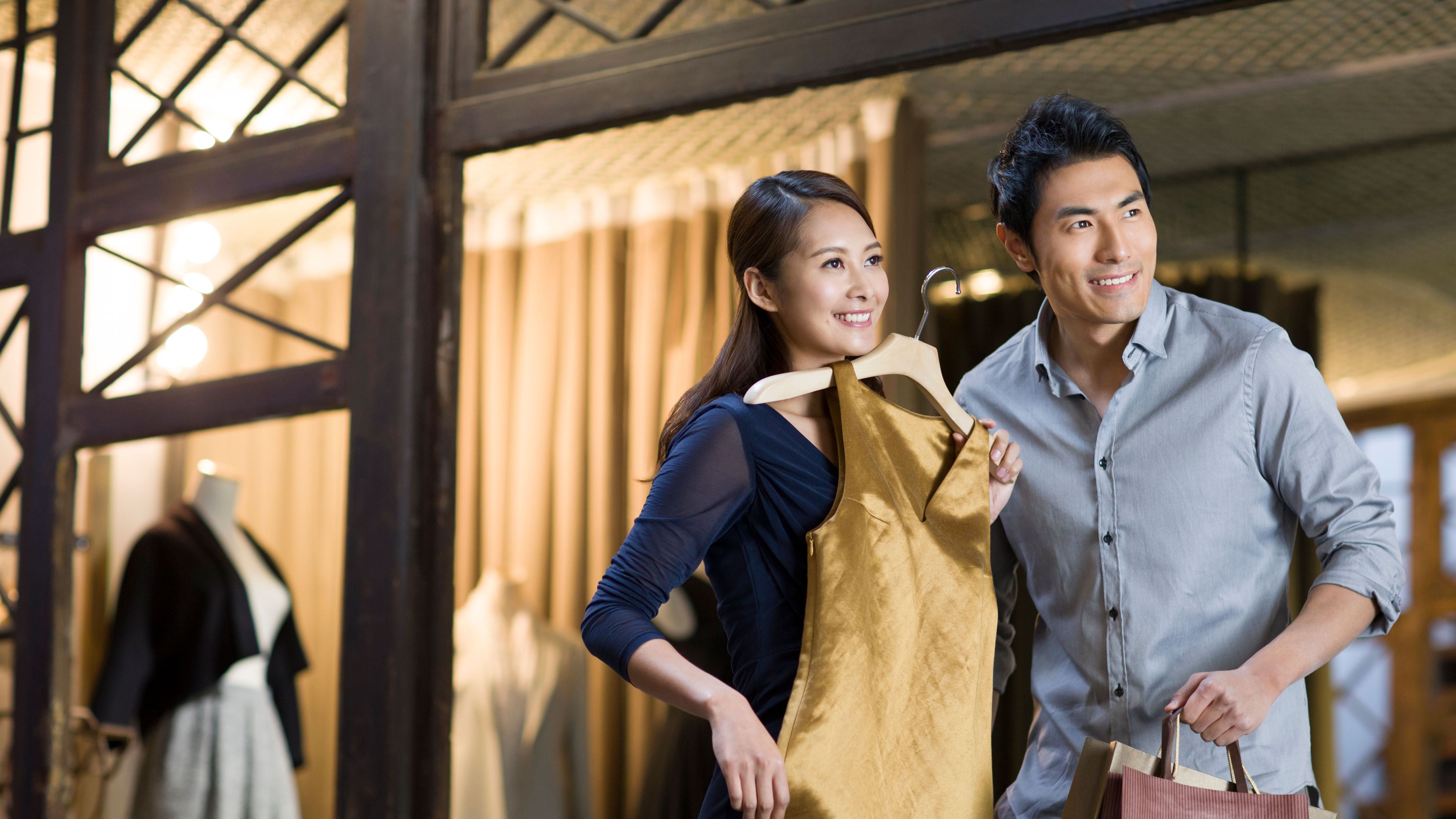 Image of Young couple choosing dress 

 